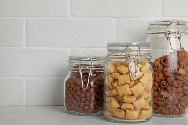 Glass Containers Different Breakfast Cereals White Countertop Brick Wall Space — Foto de Stock