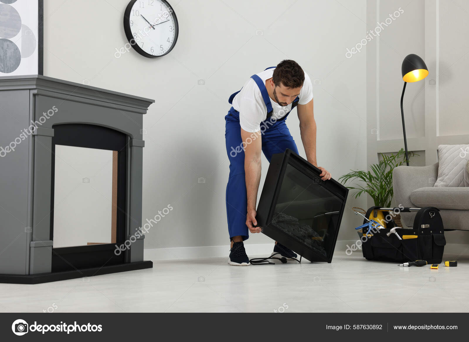 Professional Technician Installing Electric Fireplace Room Stock Photo