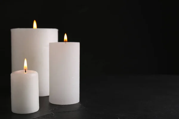 Burning Candles Slate Table Black Background Space Text — Zdjęcie stockowe