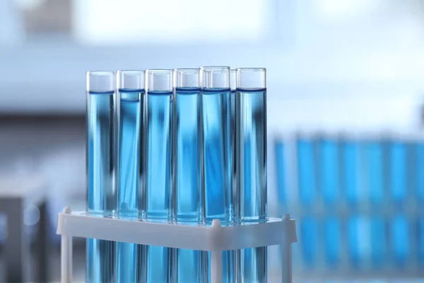 Test Tubes Light Blue Liquid Blurred Background Closeup — Stok fotoğraf