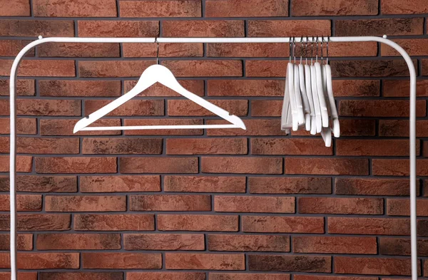 White Clothes Hangers Rack Red Brick Wall Space Text — 스톡 사진