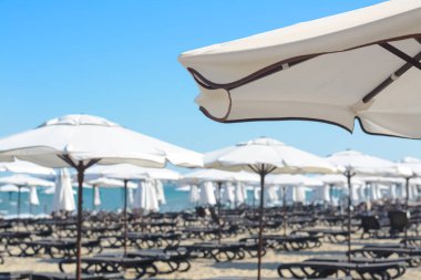 Beautiful white beach umbrella at resort, closeup. Space for text