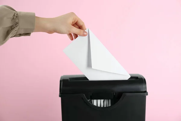 Woman Destroying Envelope Shredder Pink Background Closeup — Stockfoto