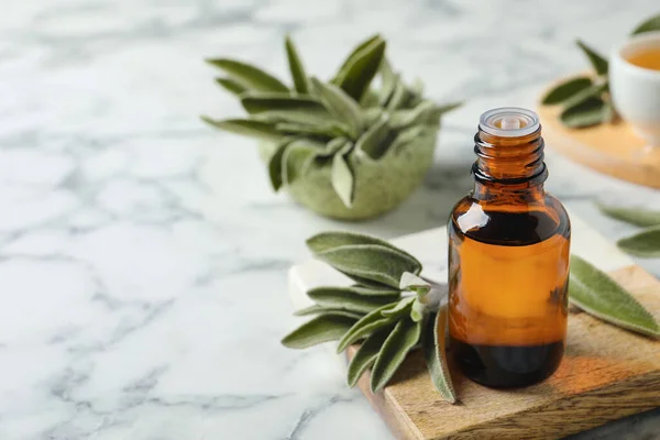 Bottle Essential Sage Oil Leaves White Marble Table Space Text — Stockfoto