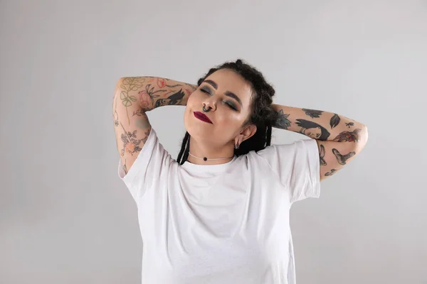 Beautiful Young Woman Tattoos Arms Nose Piercing Dreadlocks Grey Background — Zdjęcie stockowe