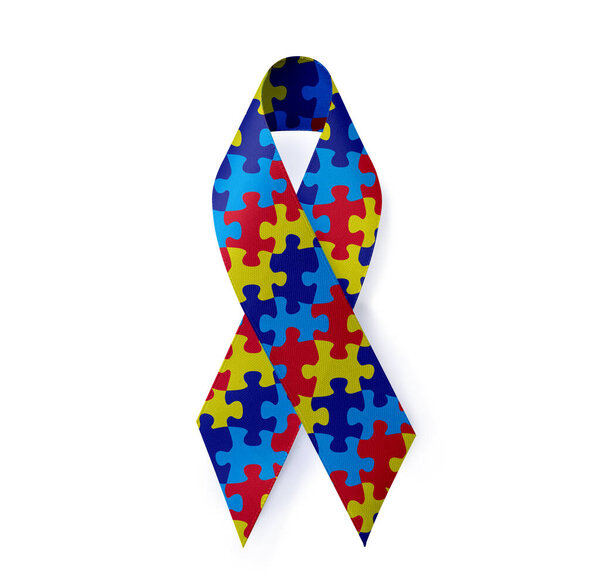 World Autism Awareness Day. Colorful puzzle ribbon on white background, top view