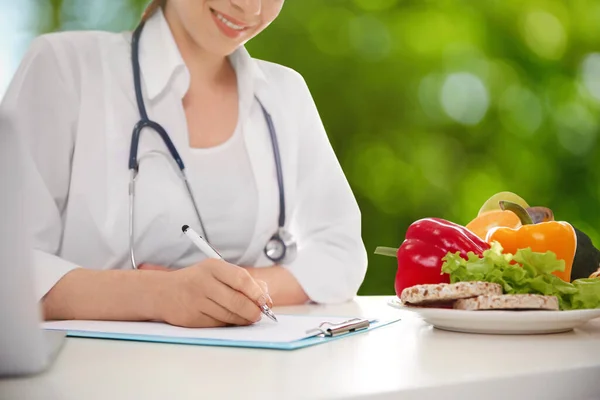 Nutritionist Working Table Blurred Green Background Closeup — Zdjęcie stockowe