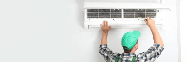 Male Technician Fixing Modern Air Conditioner Indoors Space Text Banner — Stockfoto