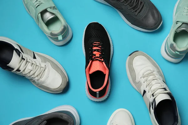 Different Stylish Sport Shoes Light Blue Background Flat Lay — Foto de Stock