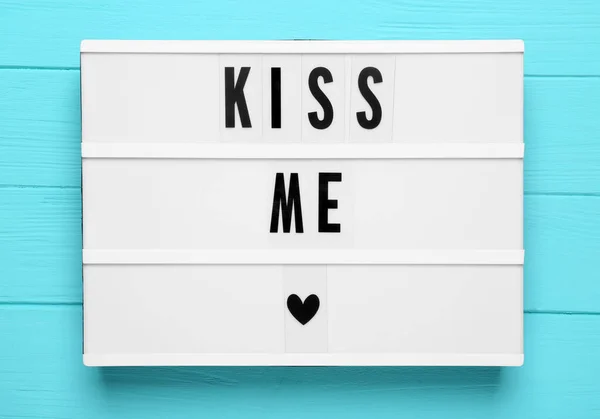 Light Box Phrase Kiss Turquoise Wooden Background Top View — Stockfoto