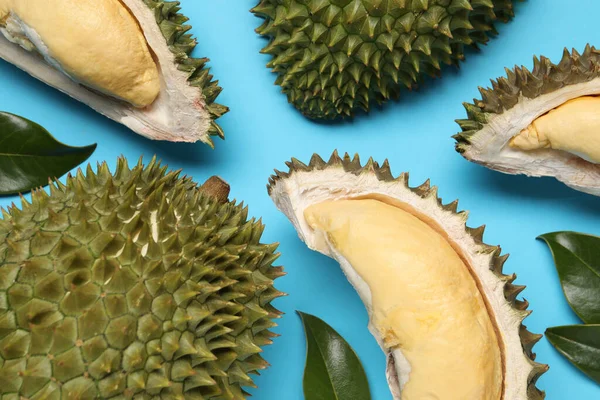 Fresh Ripe Durians Leaves Light Blue Background Flat Lay — Zdjęcie stockowe