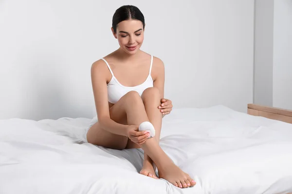 Young Woman Epilating Her Legs Bed — Foto de Stock