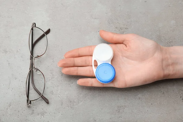 Woman Holding Case Contact Lenses Glasses Grey Table Top View — Stockfoto