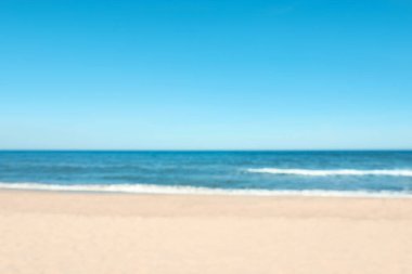 Blurred view of beautiful sea and sandy beach on sunny day