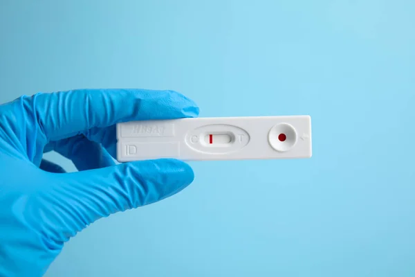 Doctor Holding Disposable Express Test Hepatitis Light Blue Background Closeup — Stockfoto