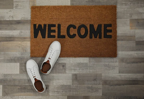 Pair Stylish White Sneakers Doormat Floor Flat Lay — Fotografia de Stock