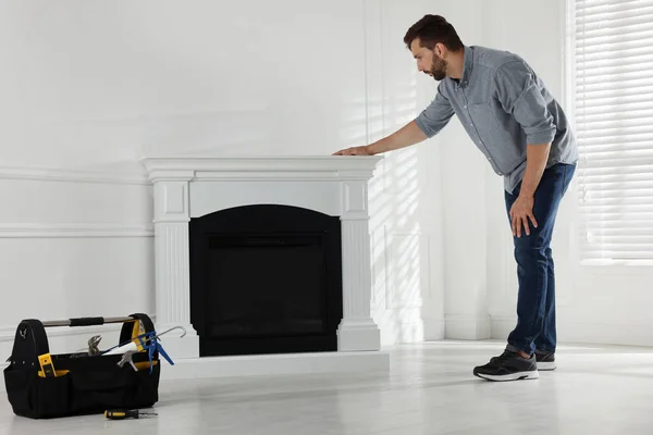 Man Installing Electric Fireplace White Wall Room — Stock fotografie