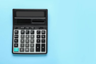Modern calculator on turquoise background, top view. Space for text