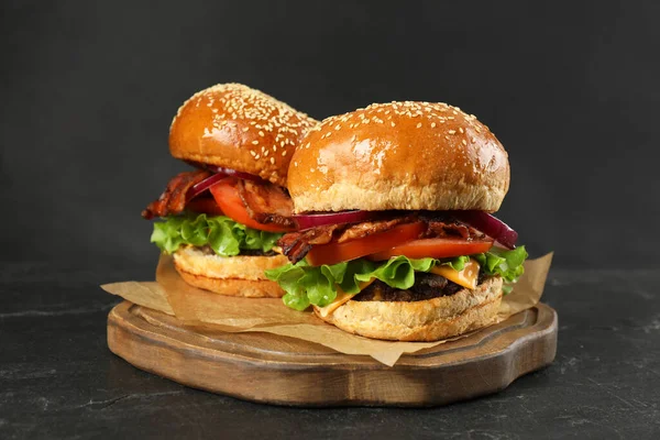 Tasty Burgers Black Wooden Table Fast Food — Stockfoto