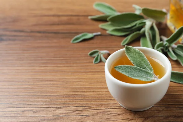 Bowl Essential Sage Oil Leaves Wooden Table Space Text — Zdjęcie stockowe