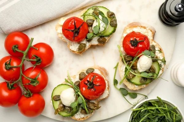 Tasty Bruschettas Capers Vegetables Mozzarella Served White Marble Table Flat — Foto Stock