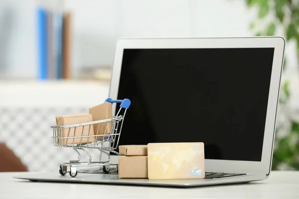 Online Fizetési Koncepció Kis Bevásárlókocsi Bankkártyával Dobozokkal Laptoppal Fehér Asztalon — Stock Fotó