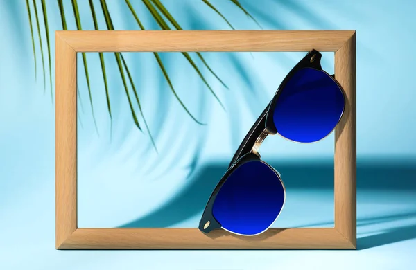 New Stylish Elegant Sunglasses Blue Lenses Blue Background — Zdjęcie stockowe