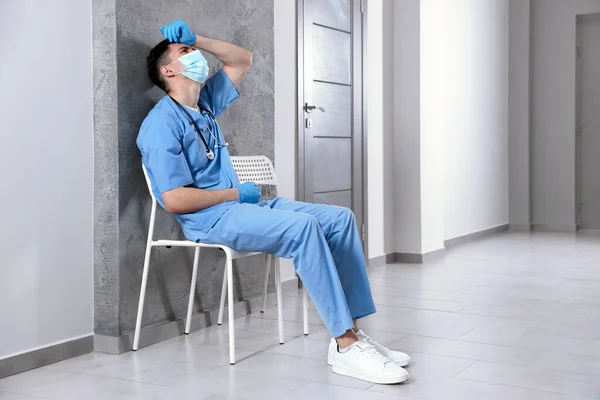 Exhausted Doctor Sitting Chair Hospital Hallway — 图库照片