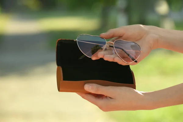 Woman Holding Sunglasses Case Blurred Background Closeup — 스톡 사진