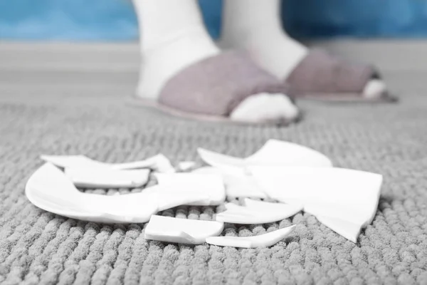 Woman Slippers Standing Broken Plate Rug Home Closeup — Φωτογραφία Αρχείου
