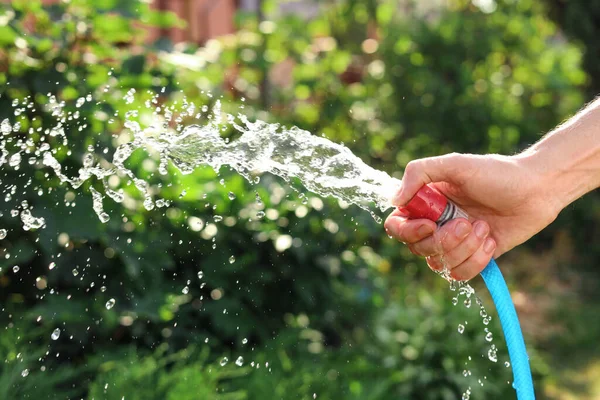 Man Pouring Water Hose Garden Closeup — Stok fotoğraf
