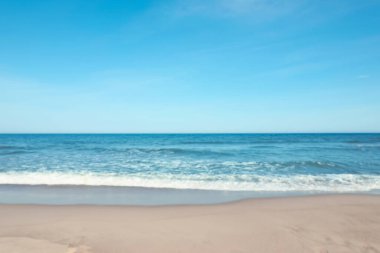 Blurred view of beautiful sea and sandy beach on sunny day
