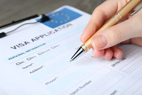 Woman Filling Visa Application Form Immigration European Union Table Closeup — ストック写真