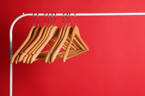 Wooden Clothes Hangers Metal Rack Red Background — Stock Photo, Image