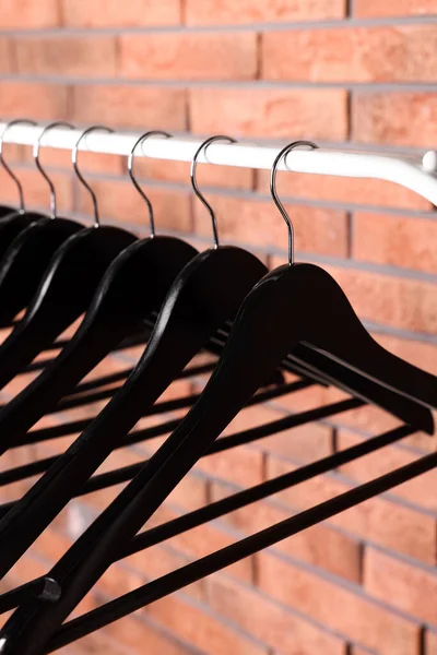 Black Clothes Hangers Rack Red Brick Wall Closeup — Foto de Stock