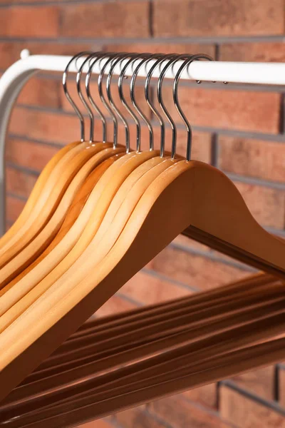 Wooden Clothes Hangers Rack Red Brick Wall Closeup — 스톡 사진
