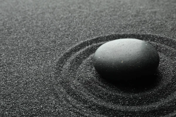 Black sand with stone and beautiful pattern. Zen concept