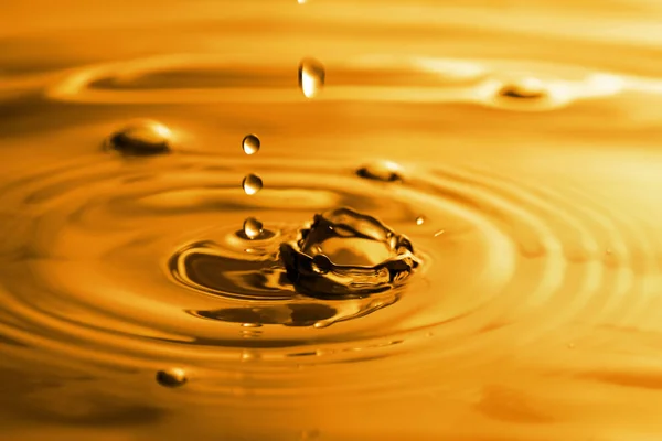 Splash Golden Oily Liquid Drops Background Closeup — Fotografia de Stock