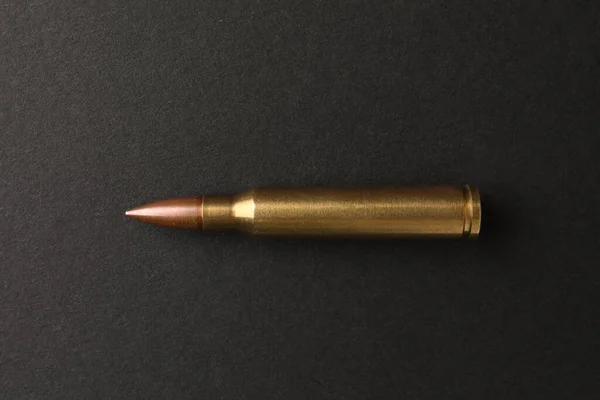 One Bullet Black Background Top View — Stockfoto
