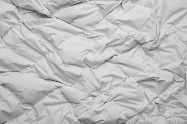 Soft crumpled blanket as background, top view