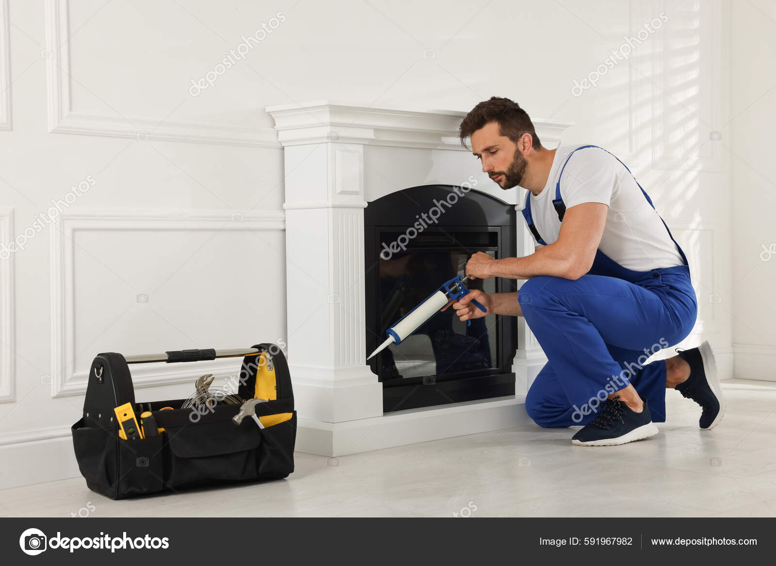 Professional Technician Sealing Electric Fireplace Caulk White Wall