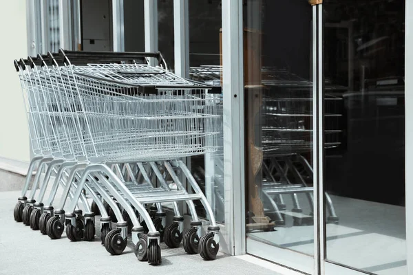 Row of shopping carts near store outdoors