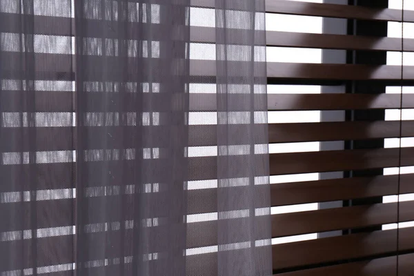 Window with beautiful curtain and blinds, closeup