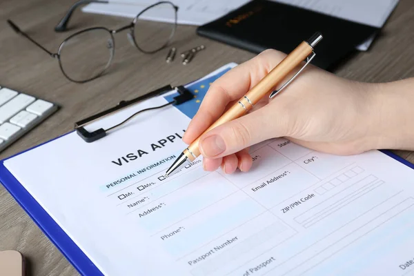 Woman Filling Visa Application Form Immigration European Union Wooden Table — Foto Stock