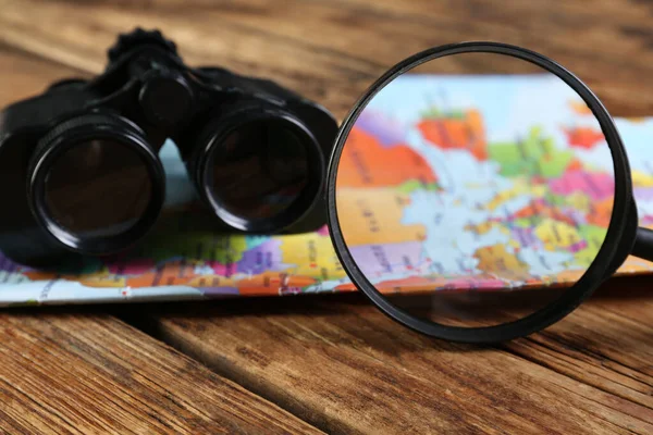 Magnifying Glass Modern Binoculars Map Wooden Table Closeup — Stock Photo, Image