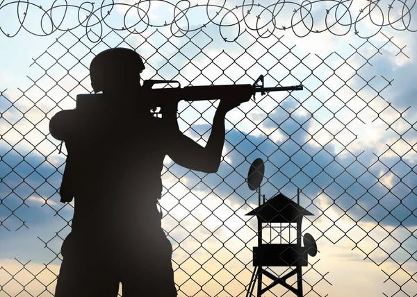 Silhouette of border guard at post outdoors in early morning