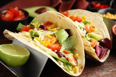 Tahta masada karidesli, peynirli ve limonlu leziz tacolar.