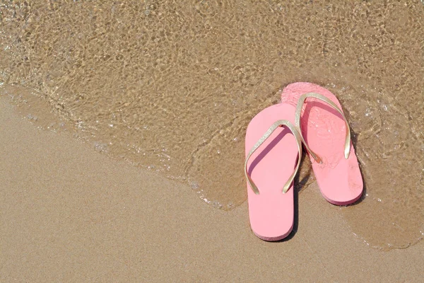 Stylish Pink Flip Flops Wet Sand Getting Hit Sea Wave — Stock Photo, Image