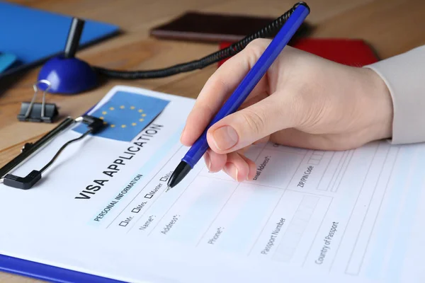 Woman Filling Visa Application Form Immigration European Union Table Closeup — Stockfoto