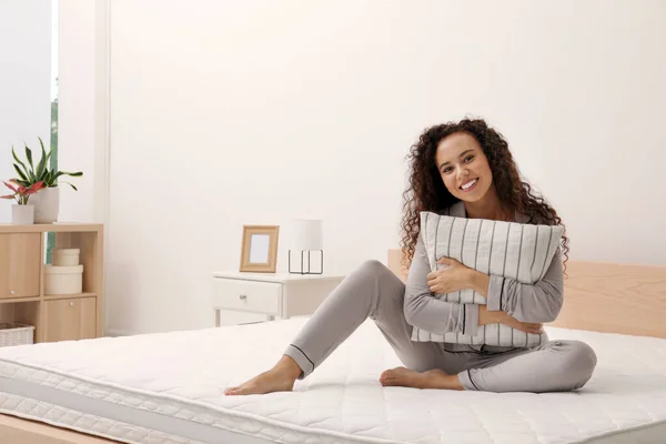 Happy Young African American Woman Hugging Pillow Bed Comfortable Mattress — стоковое фото